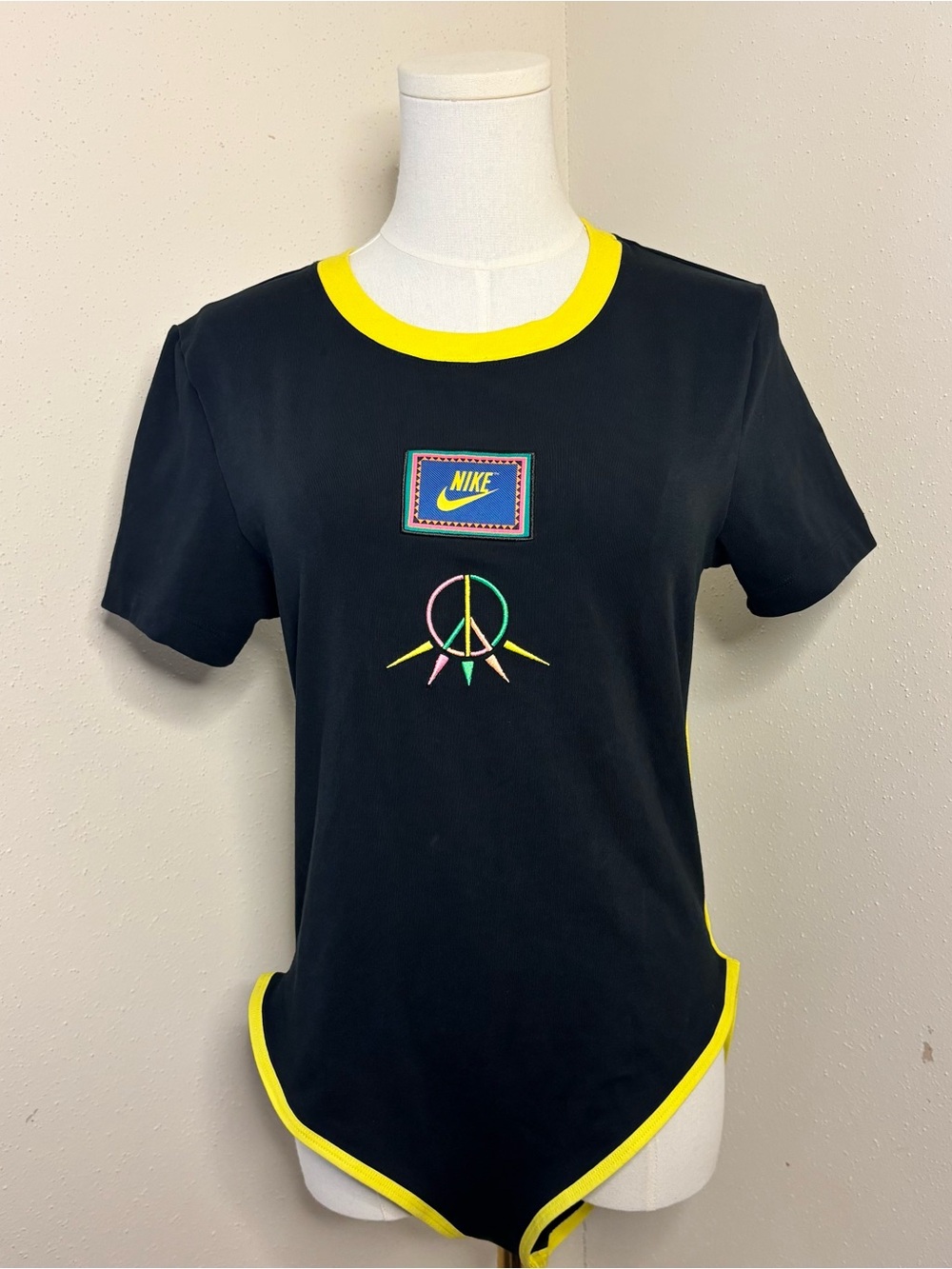 Nike Black Women’s Short Sleeve Bodysuit with Essentials Heritage Peace